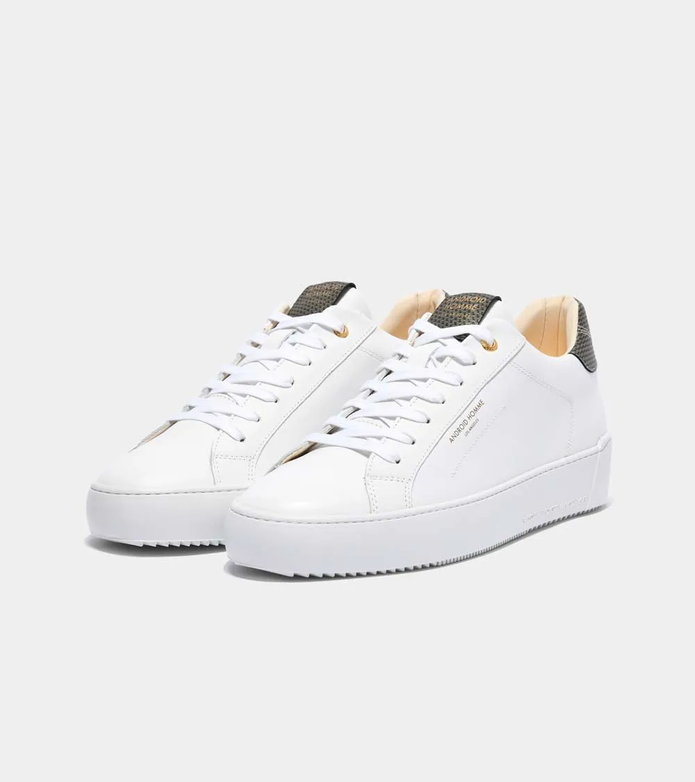 Sure! Here’s an optimized title for your e-commerce product:

Zuma Luxury White Leather Sneakers with Gold Carbon Fiber Detail - Model AHP211-38

This title adds descriptive modifiers that highlight the luxury aspect, the style (sneakers), and the materials involved.