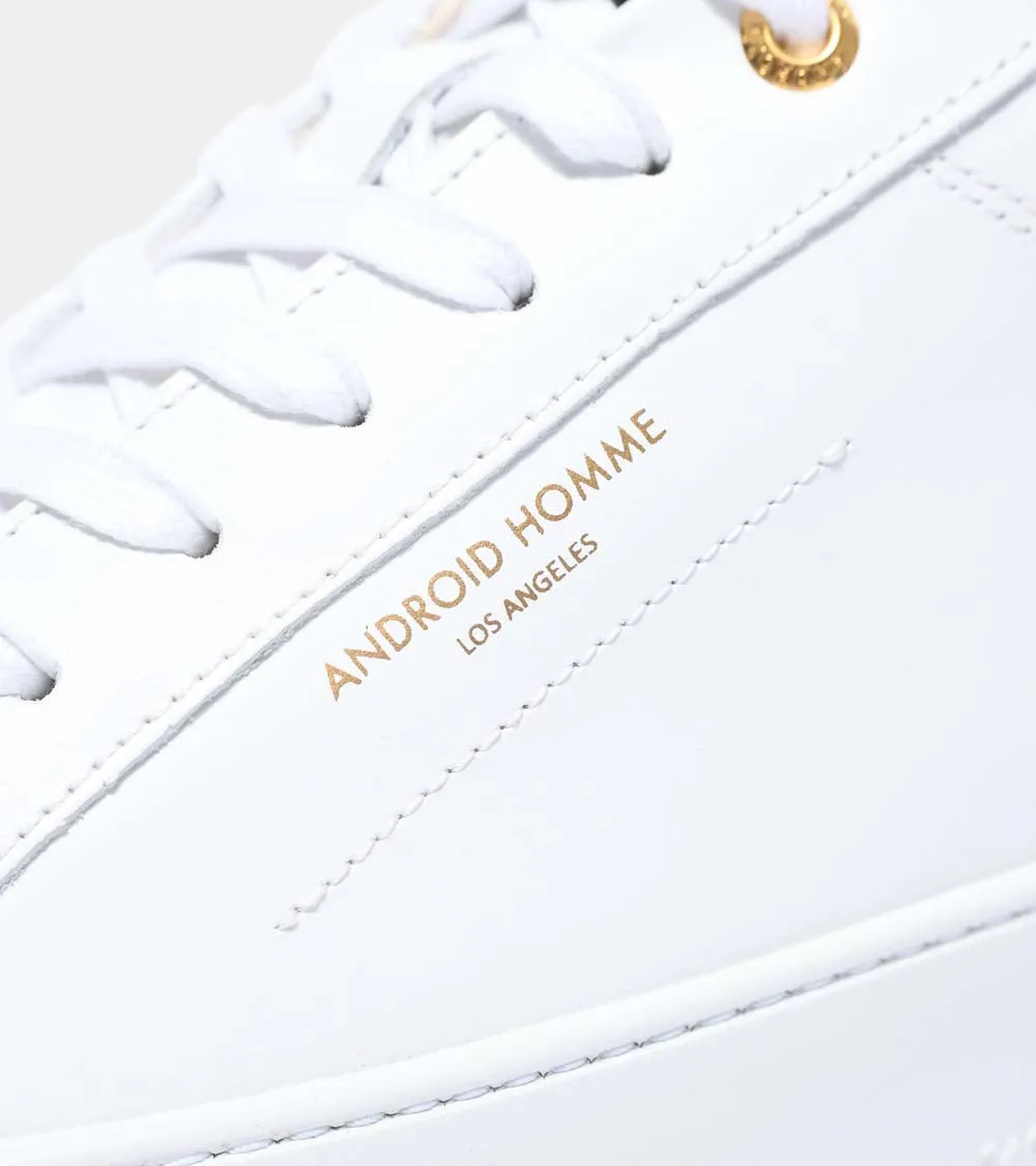 Sure! Here’s an optimized title for your e-commerce product:

Zuma Luxury White Leather Sneakers with Gold Carbon Fiber Detail - Model AHP211-38

This title adds descriptive modifiers that highlight the luxury aspect, the style (sneakers), and the materials involved.