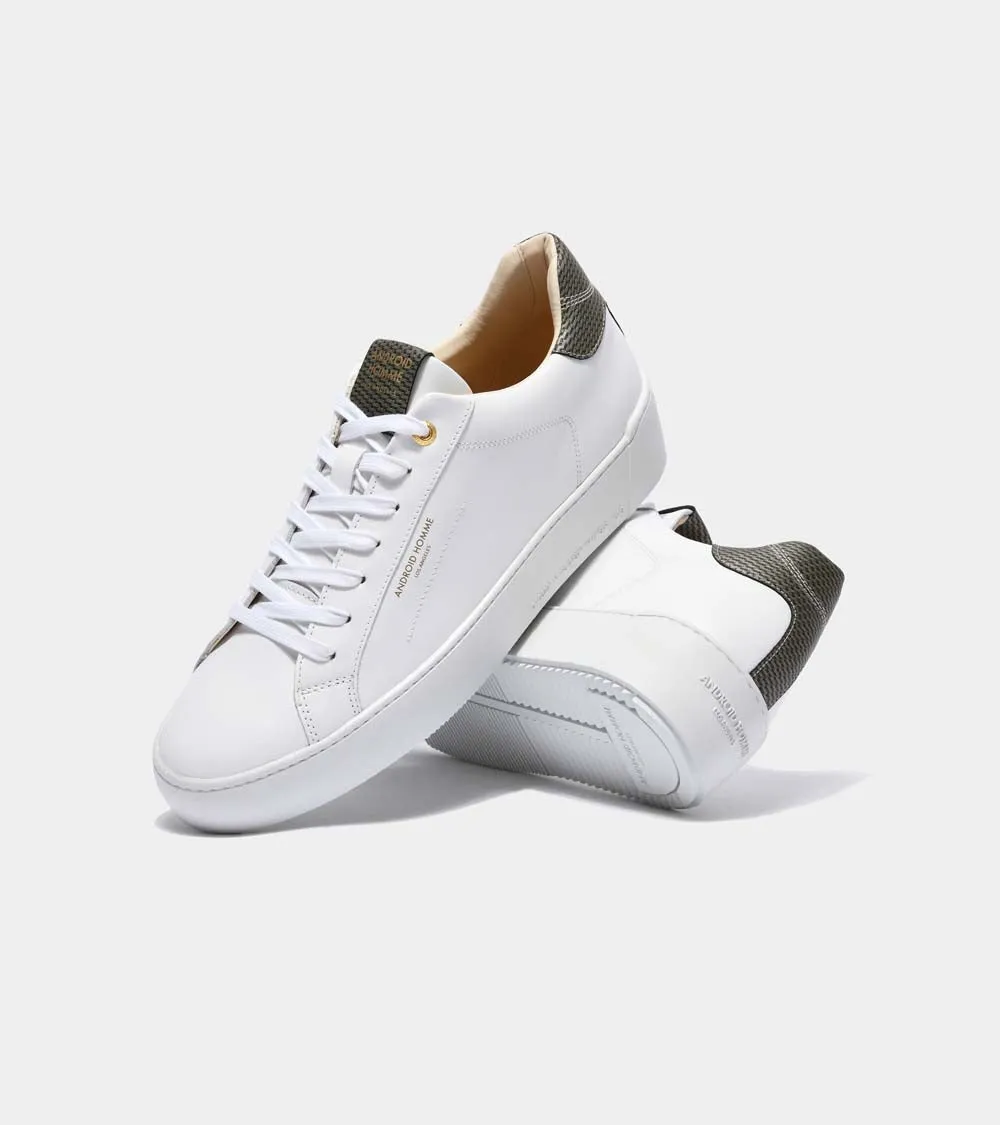 Sure! Here’s an optimized title for your e-commerce product:

Zuma Luxury White Leather Sneakers with Gold Carbon Fiber Detail - Model AHP211-38

This title adds descriptive modifiers that highlight the luxury aspect, the style (sneakers), and the materials involved.